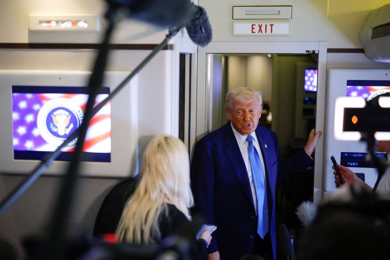 President Donald Trump speaks to members of the media aboard Air Force One, in Abu Dhabi, United Arab Emirates, on Friday.